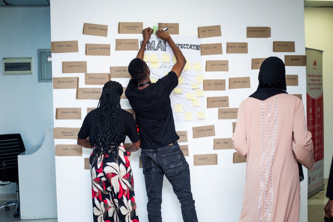 Delegates pinning notes on the EMAI expectations board